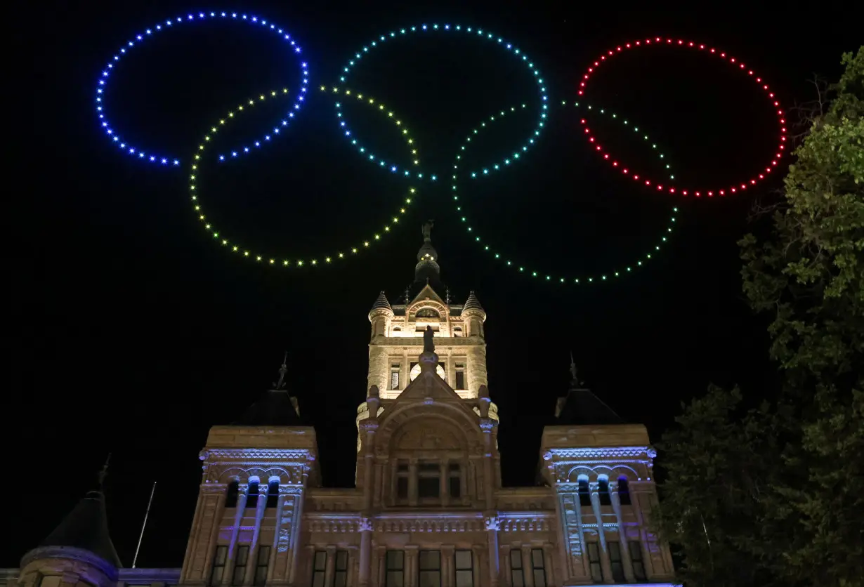 People celebrate as Salt Lake City is officially awarded the rights to host the 2034 Winter Olympic and Paralympic Games