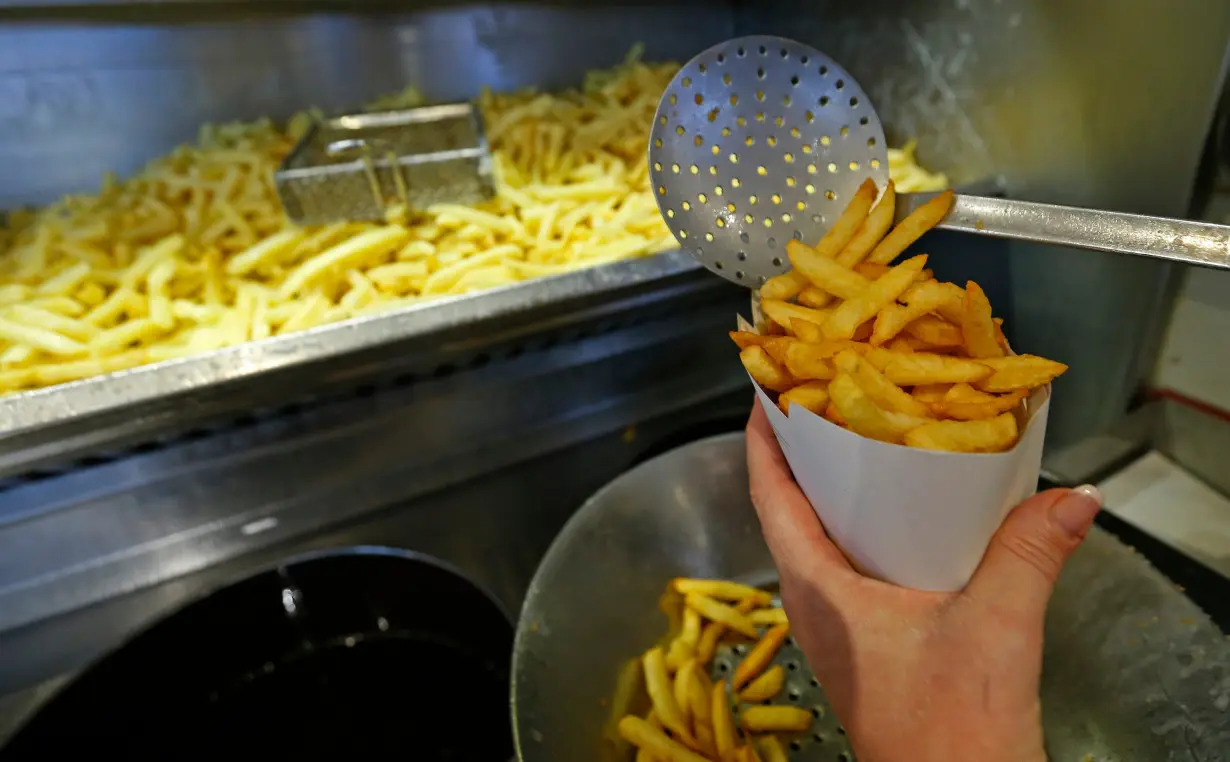 Carine Willaert prepares fries in the Maison Antoine frites stand in Brussels