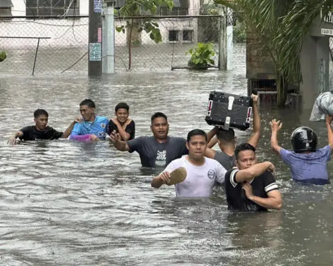 A typhoon kills 3 as it nears Taiwan. It killed 13 in the Philippines, where people plead for rescue