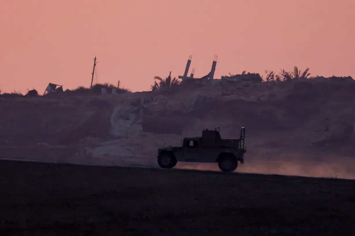 Military vehicle patrols at the Israel-Gaza border, as seen from Israel