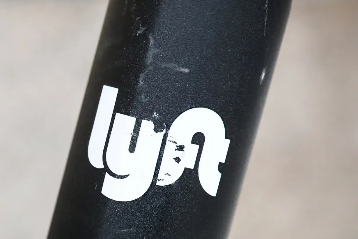 The Lyft logo is seen on a parked Lyft Scooter in Washington