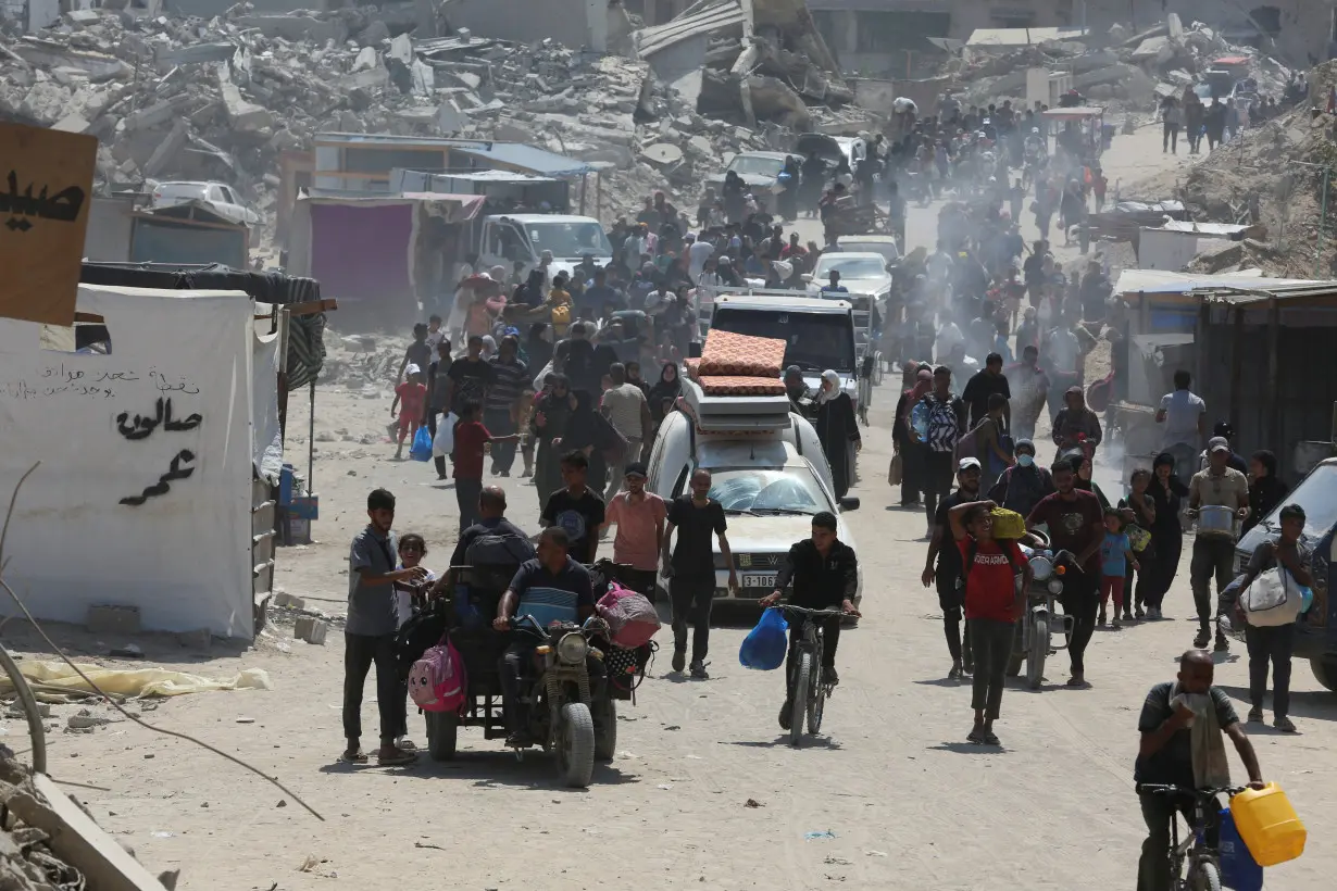 Palestinians flee the eastern parts of Khan Younis after Israeli evacuation order, in the southern Gaza Strip