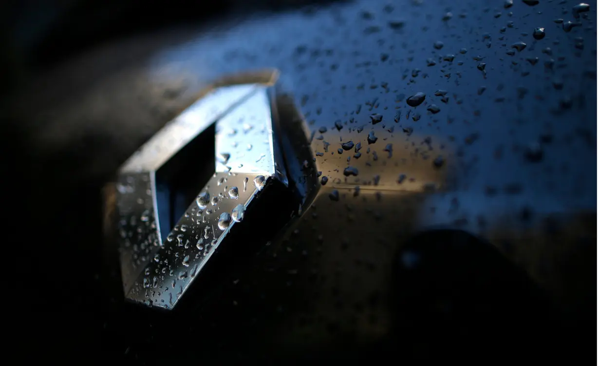 Raindrops cover the logo of French car manufacturer Renault on a automobile seen in Paris