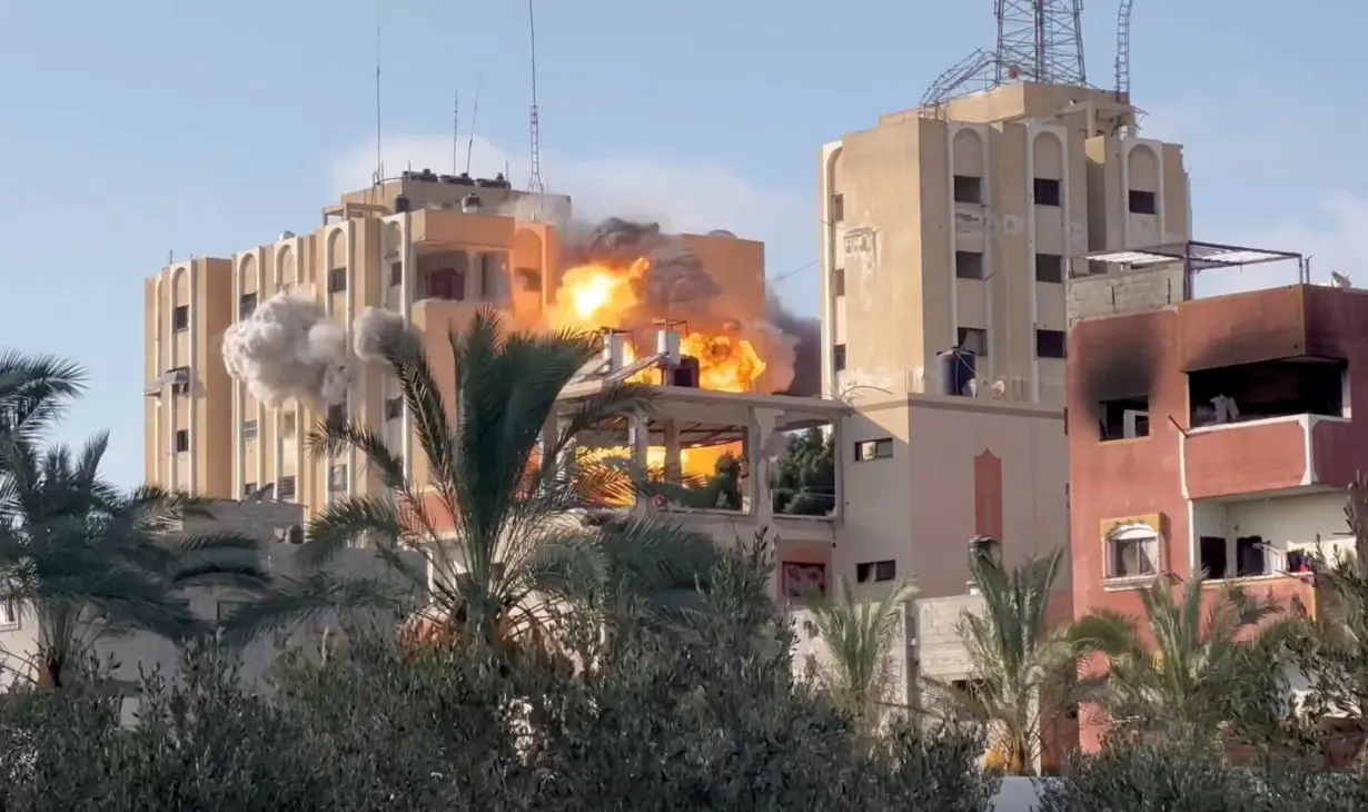 Smoke and flames rise following an Israeli strike on a residential building, amid the ongoing conflict between Israel and Hamas