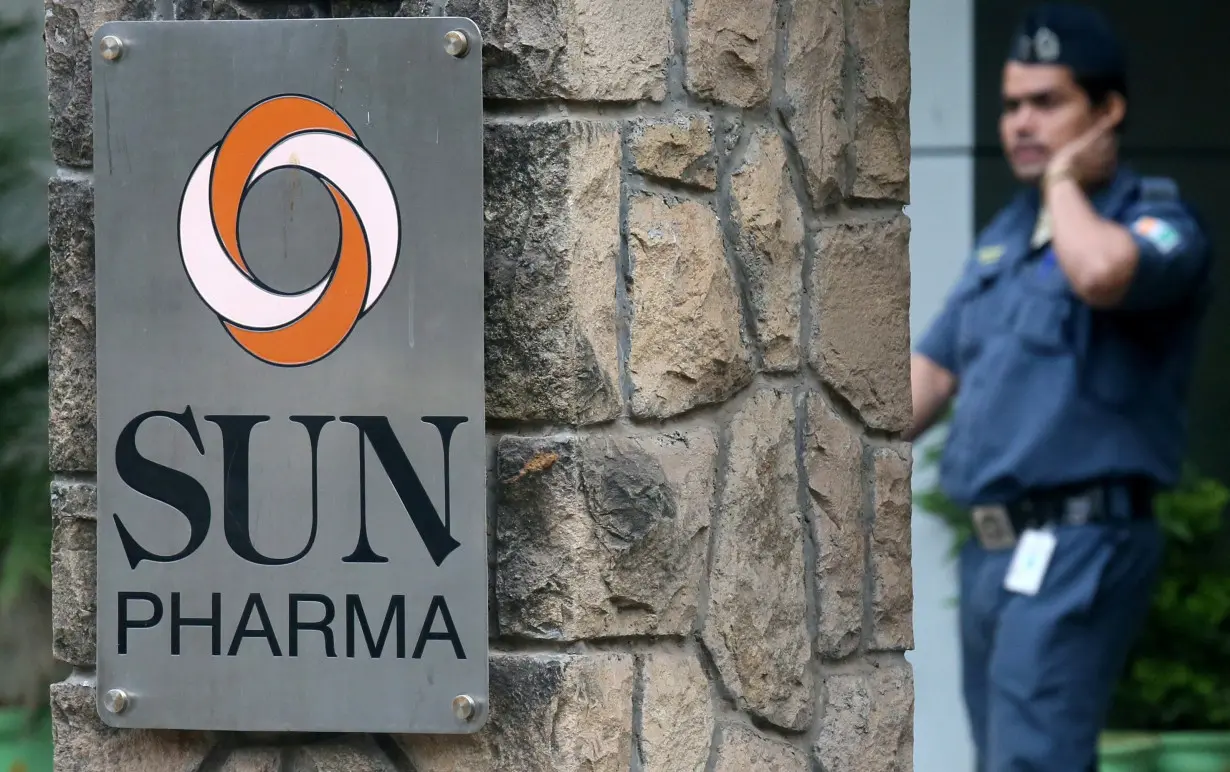 FILE PHOTO: A guard walks inside the office of Sun Pharmaceutical Industries Ltd in Mumbai