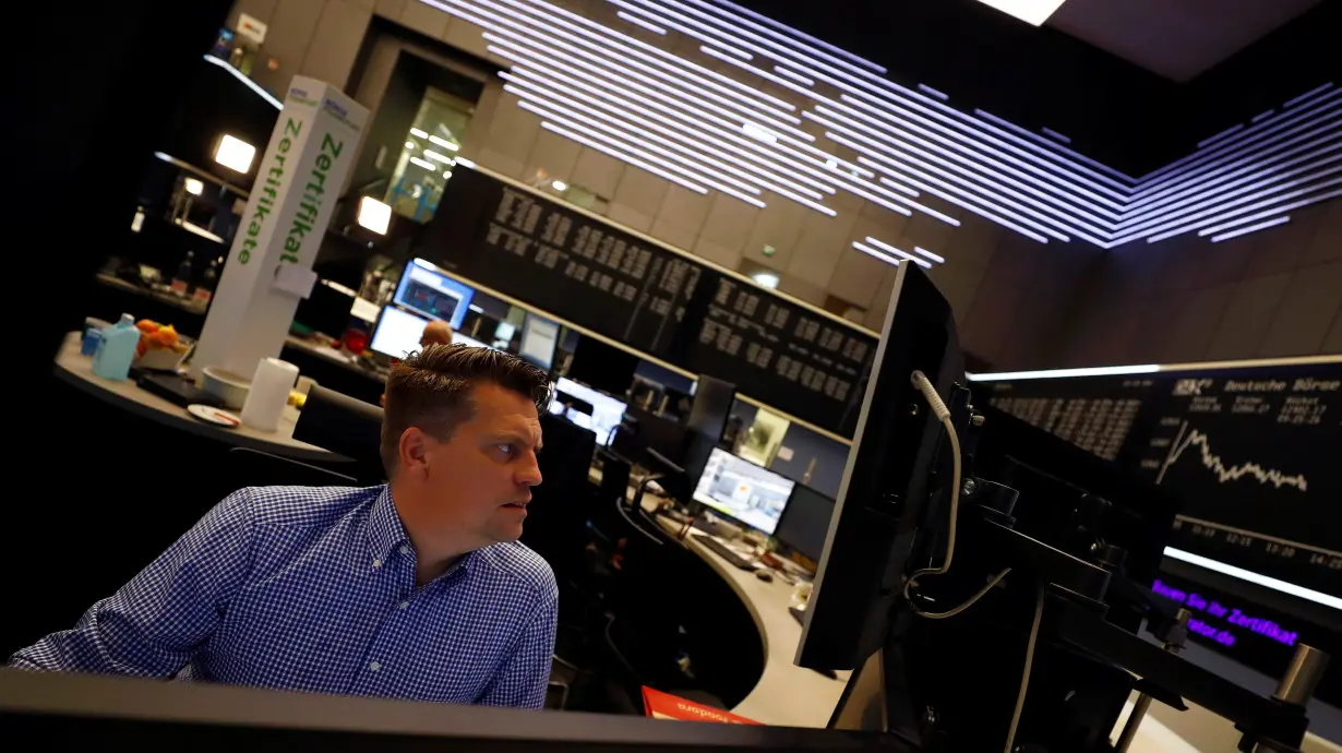 A share trader checks his screens at the stock exchange in Frankfurt