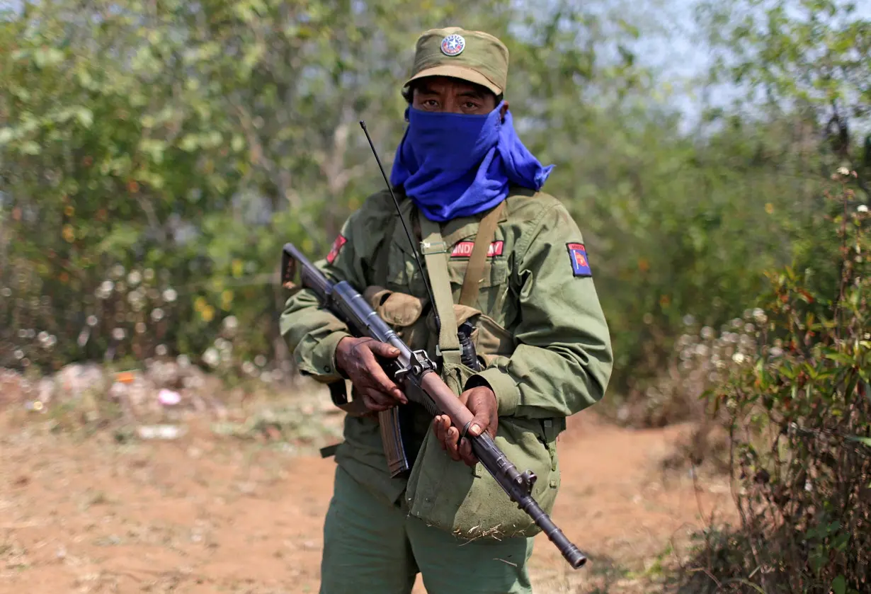 FILE PHOTO: A rebel soldier of the Myanmar National Democratic Alliance Army (MNDAA) holds his rifle as he guards near a military base in Kokang region