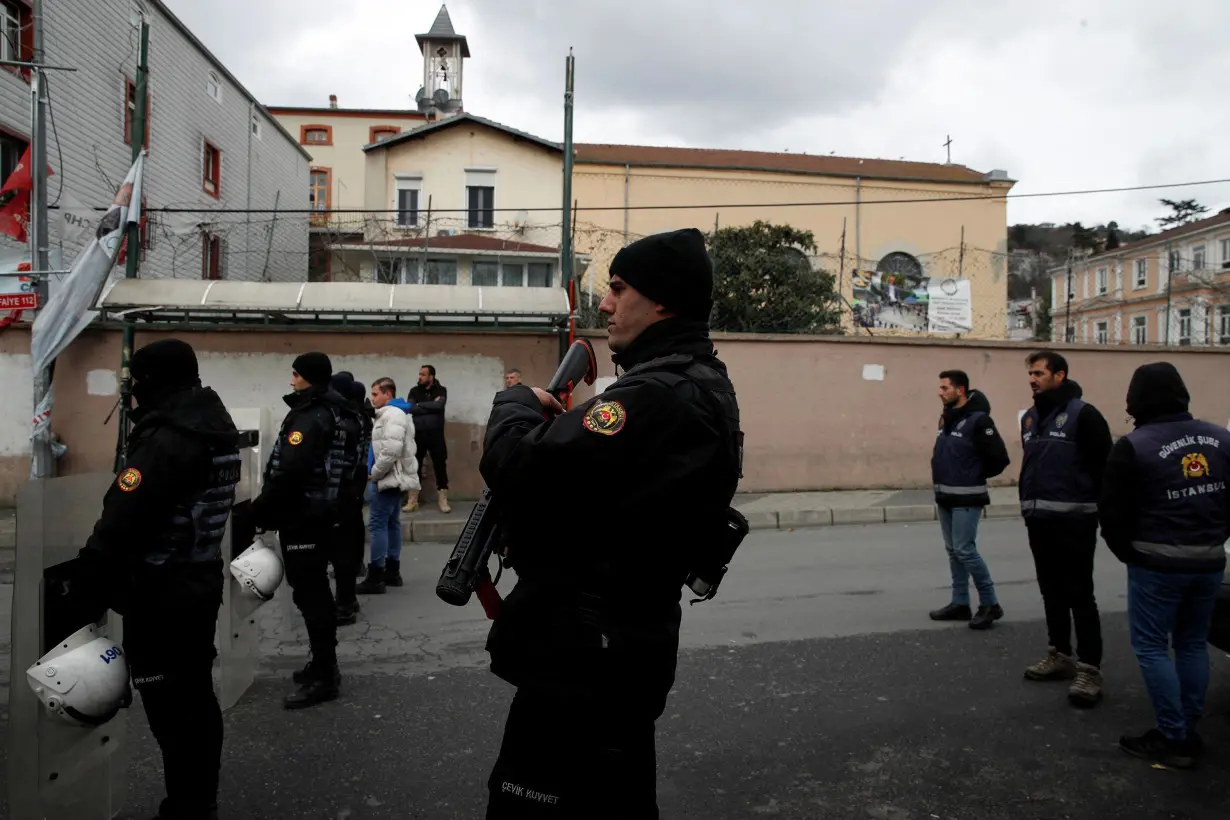 Turkish police stand guard outside the Italian Santa Maria Catholic Church after two masked gunmen shot one person dead during Sunday service, in Istanbul, Turkey, on January 28.