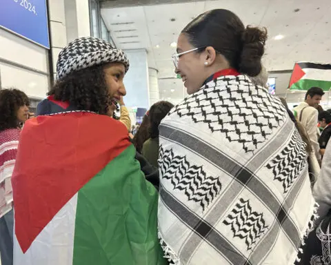 Palestinian Olympic team greeted with cheers and gifts in Paris