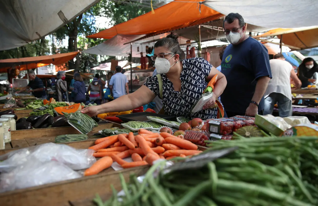 Consumers shop at a weekly street market in Rio de Janeiro