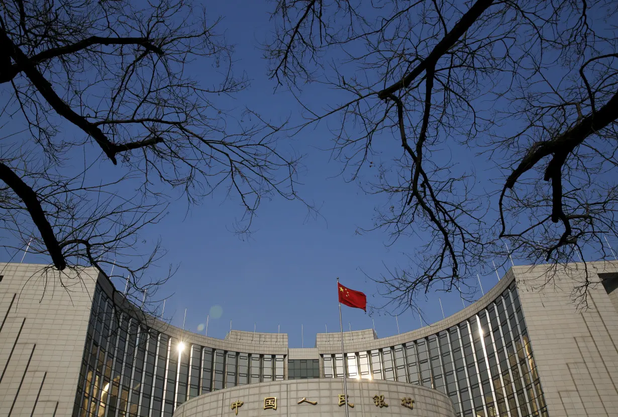 A Chinese national flag flies at the headquarters of the People's Bank of China, the country's central bank, in Beijing