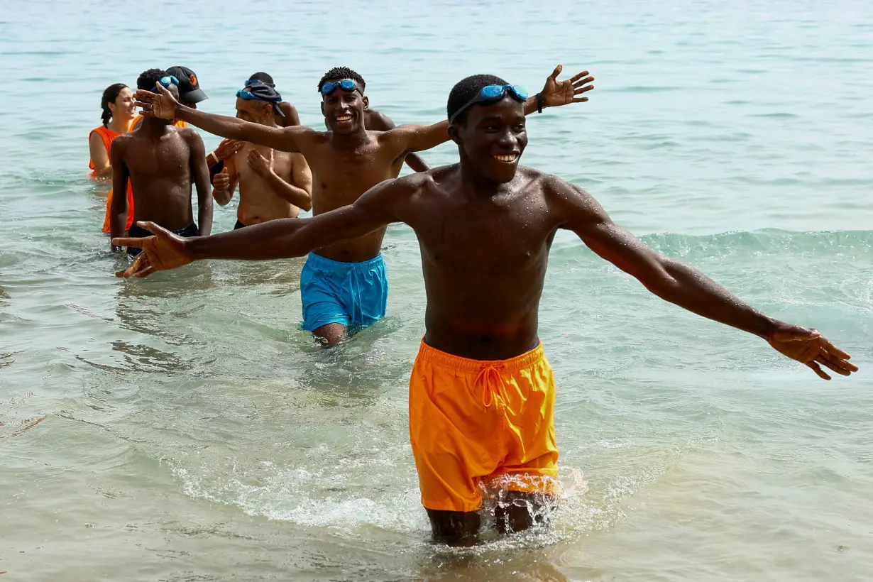 Migrants take part in the activity organized by the NGO ProemAID's 