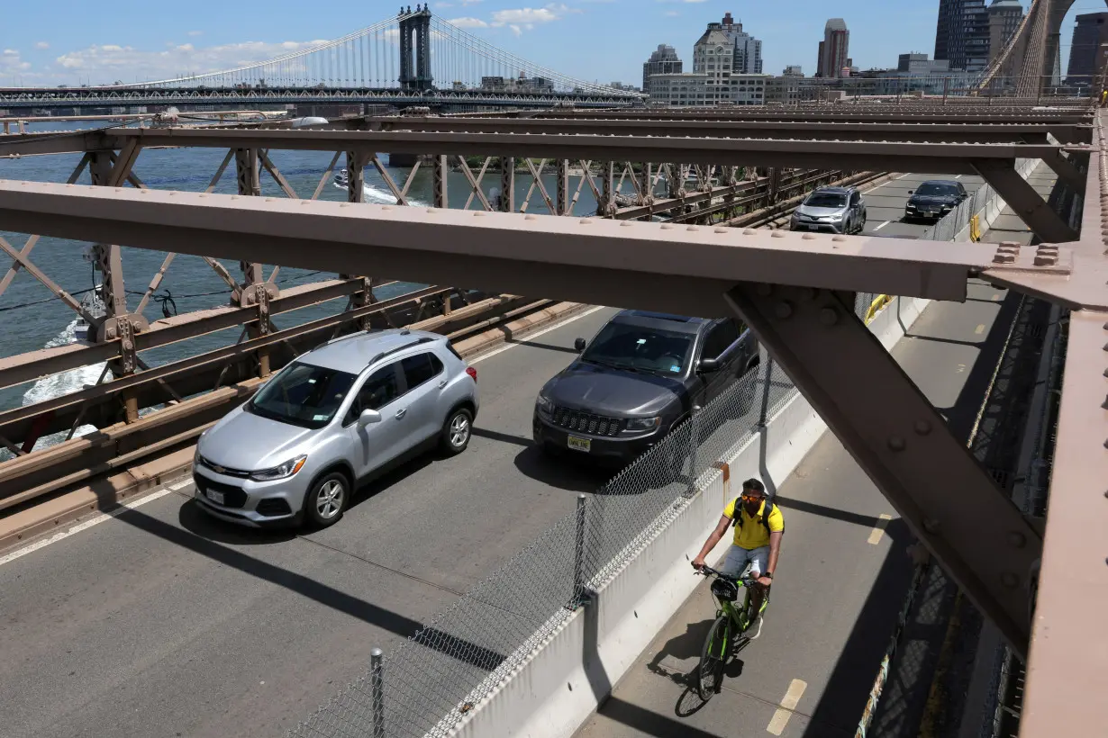 FILE PHOTO: A person rides a bicycle in a bike lane on the Brooklyn Bridge in New York City