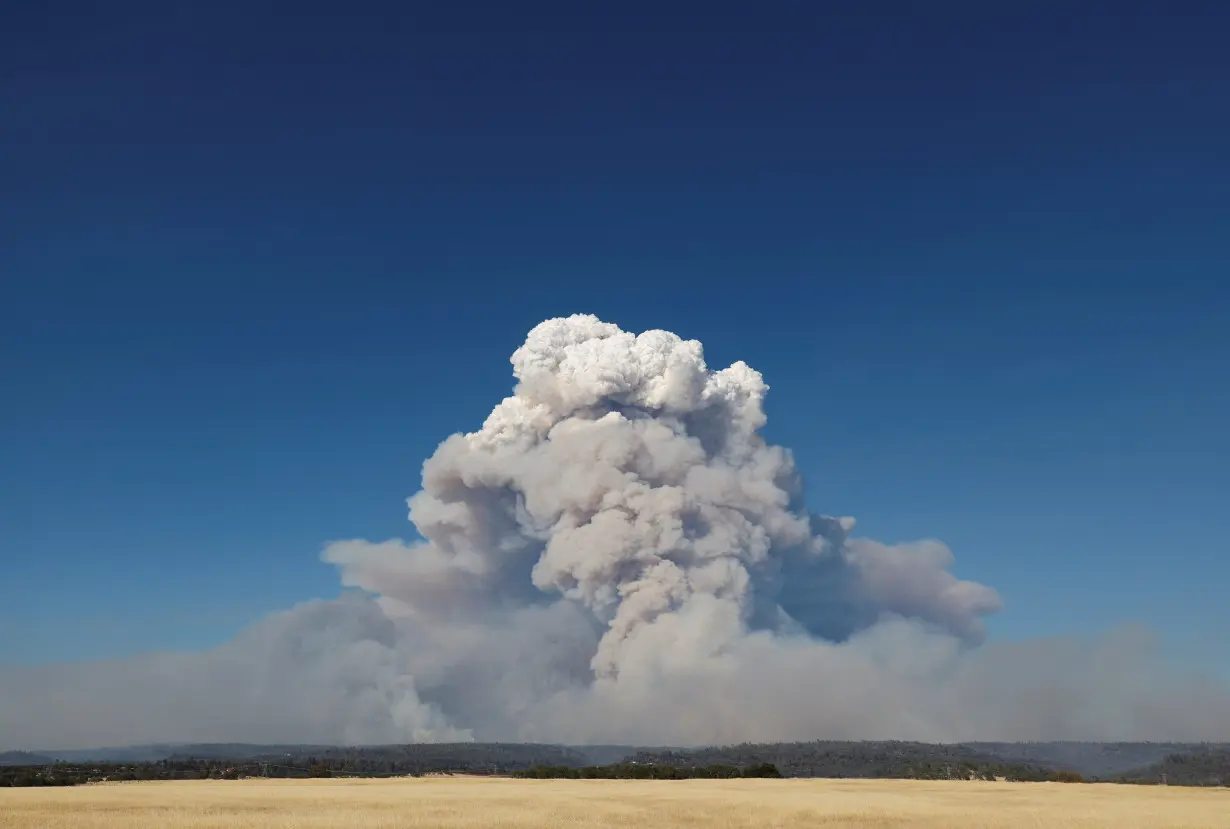 Man started California wildfire by pushing burning car into gully, prosecutor says