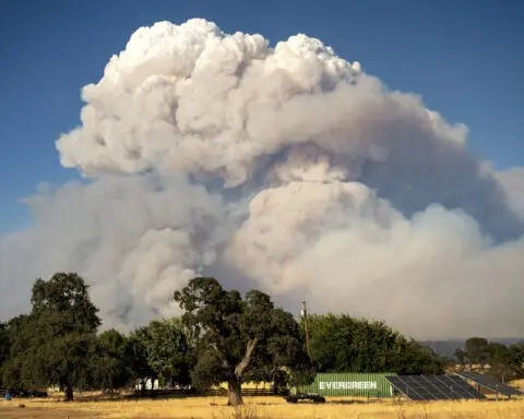 Lightning and a burning car pushed into a gully are blamed for wildfires scorching the West