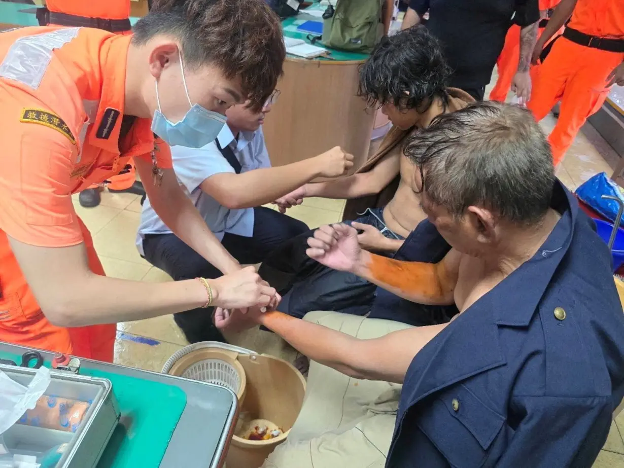 Handout image of sailors whose cargo ship Fu Shun had sunk due to Typhoon Gaemi