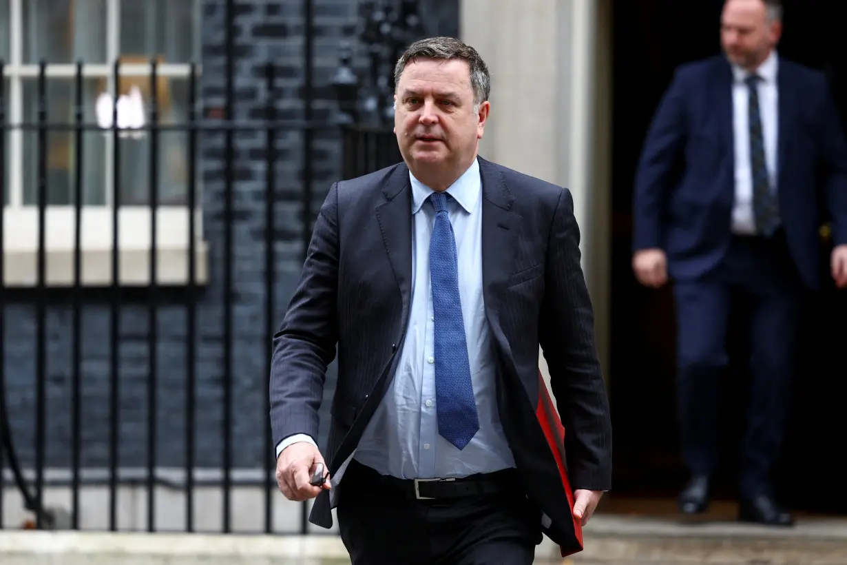 Britain's Secretary of State for Work and Pensions Stride walks outside Downing Street, in London