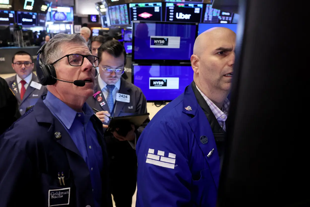 Traders work on the floor of the NYSE in New York