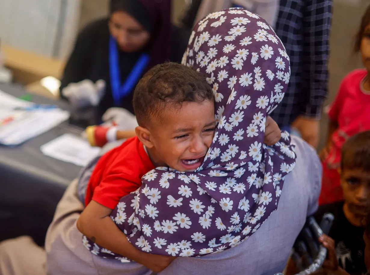 FILE PHOTO: Malnourished Palestinian children receive treatment at the IMC field hospital in Deir Al-Balah, central Gaza Strip