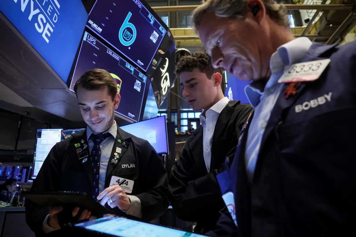 Traders work on the floor of the NYSE in New York