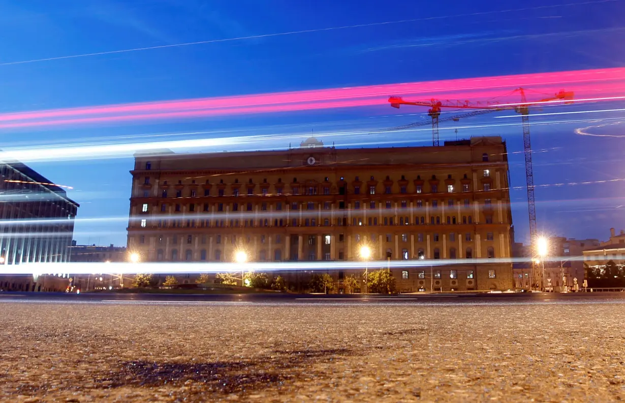 Cars drive near headquarters of the Federal Security Service in Moscow