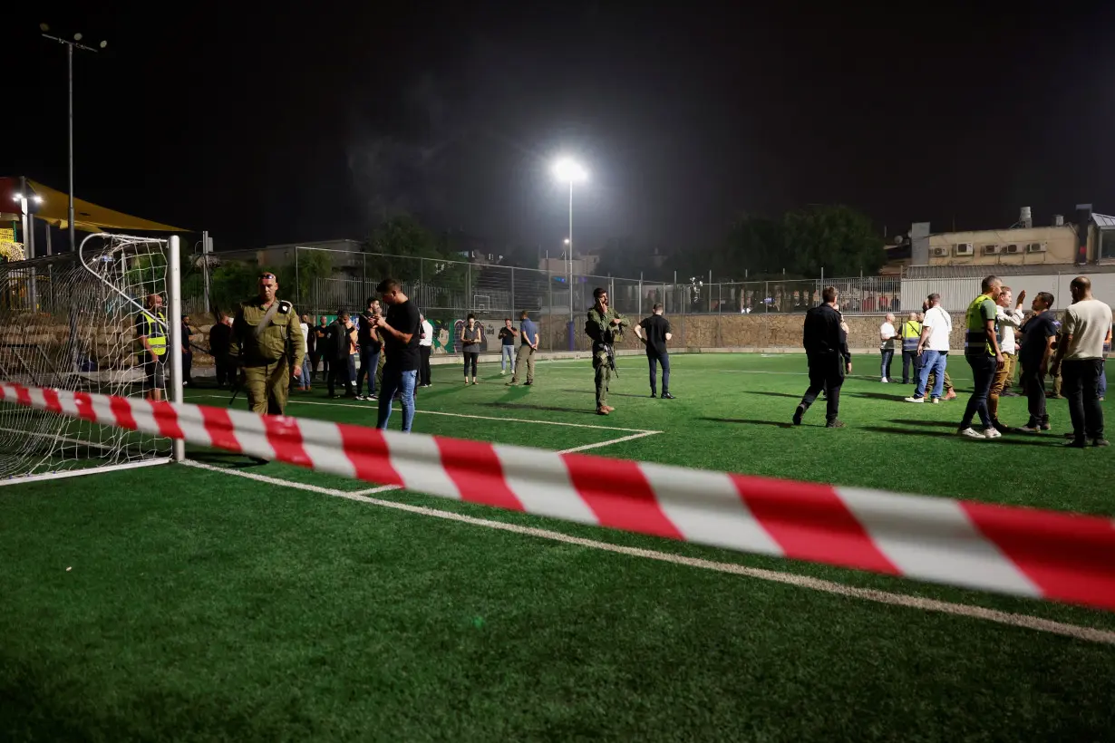 Israel says Hezbollah rocket kills 12 at football ground, vows response