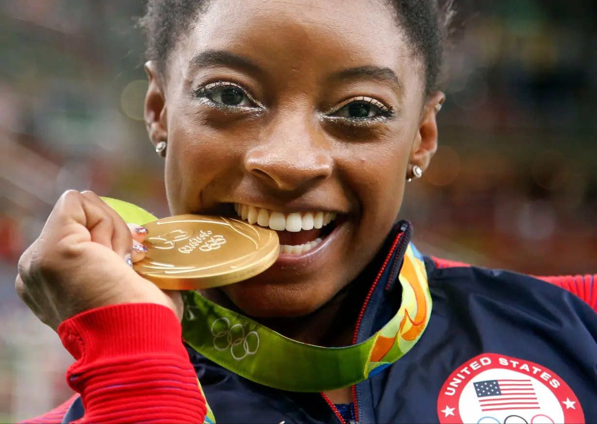 Simone Biles celebrates winning one of her four gold medals at the 2016 Rio Olympics.