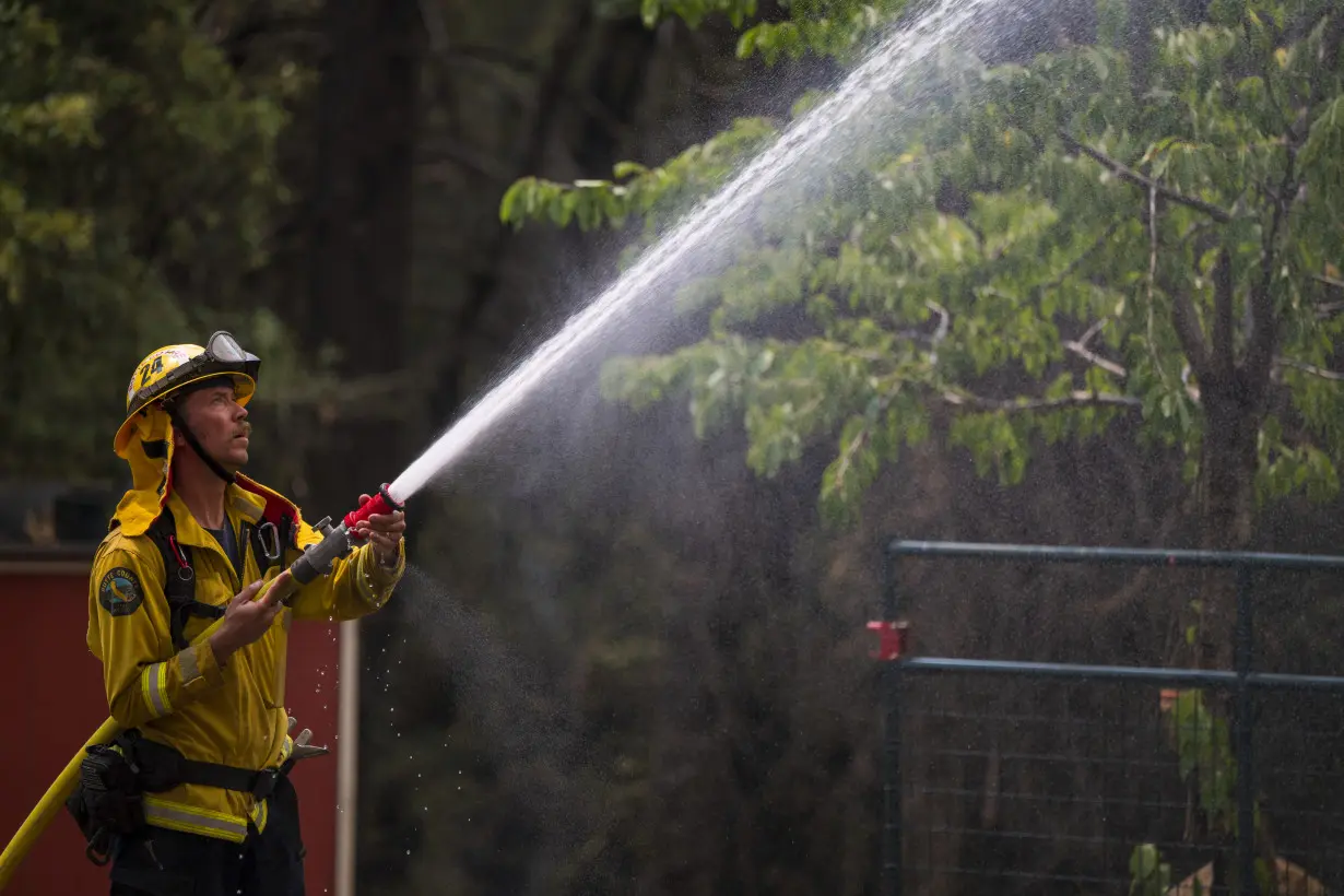 Firefighters helped by cooler weather battle blaze that has scorched area size of Los Angeles