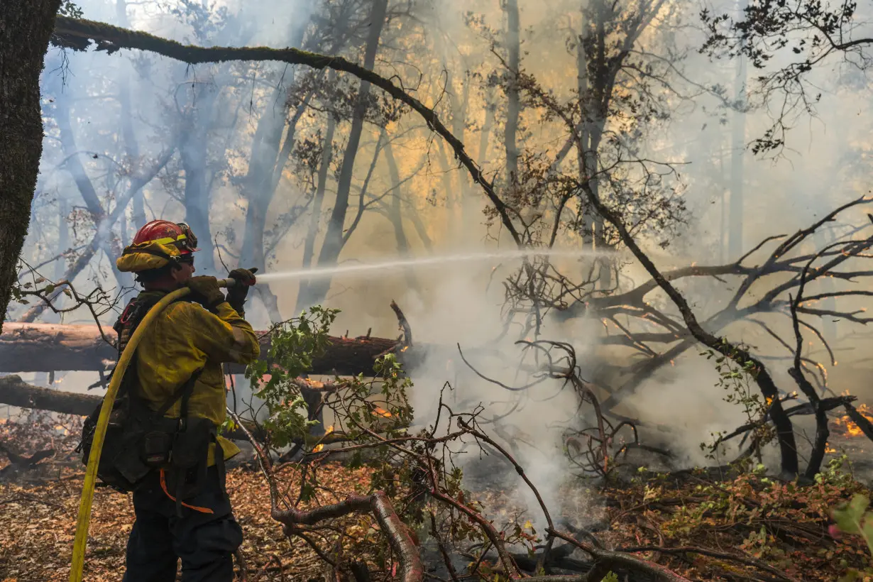 Firefighters helped by cooler weather battle blaze that has scorched area size of Los Angeles