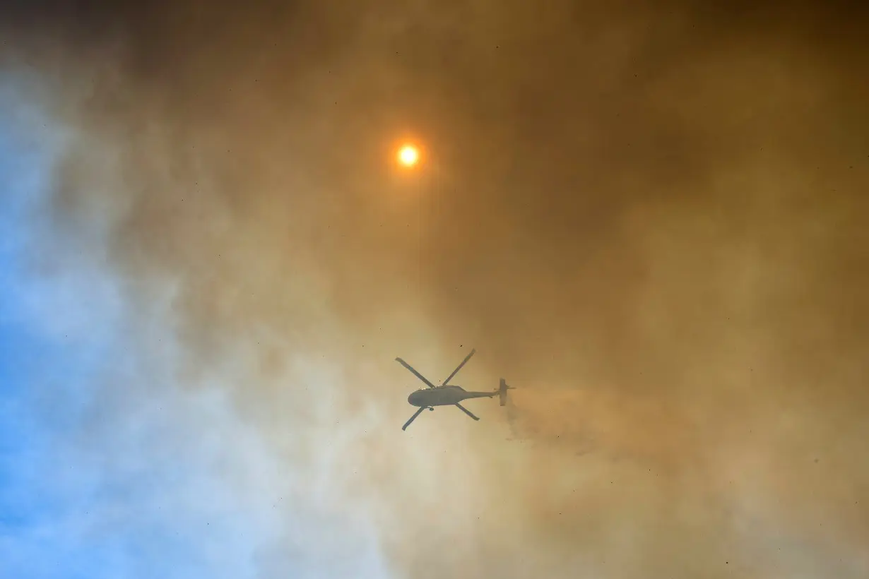 Firefighters helped by cooler weather battle blaze that has scorched area size of Los Angeles