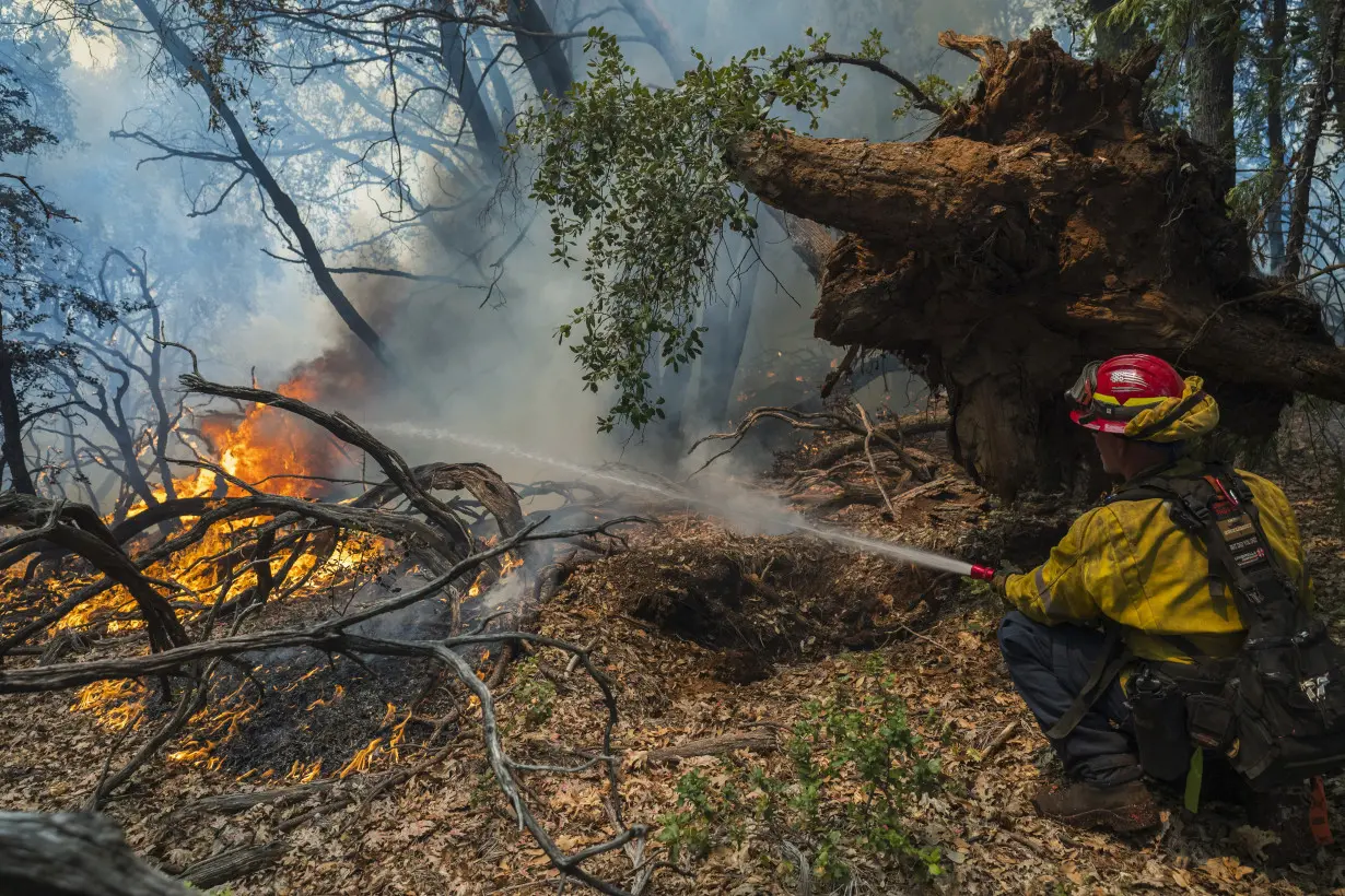 Firefighters helped by cooler weather battle blaze that has scorched area size of Los Angeles