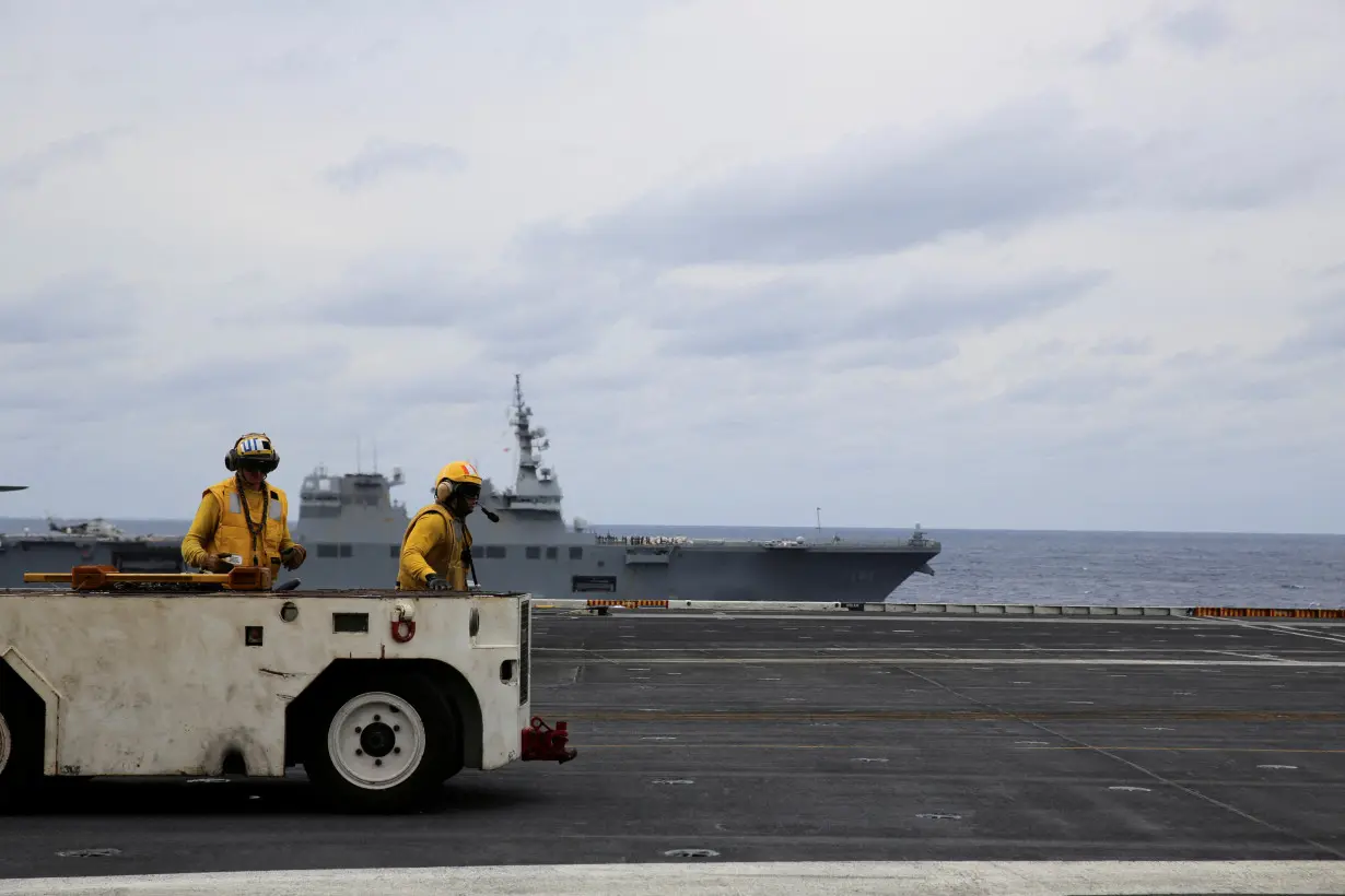 United States Seventh Fleet conducts joint exercises aboard USS Carl Vinson flanked by Japan's helicopter carrier Hyuga, in the Pacific Ocean