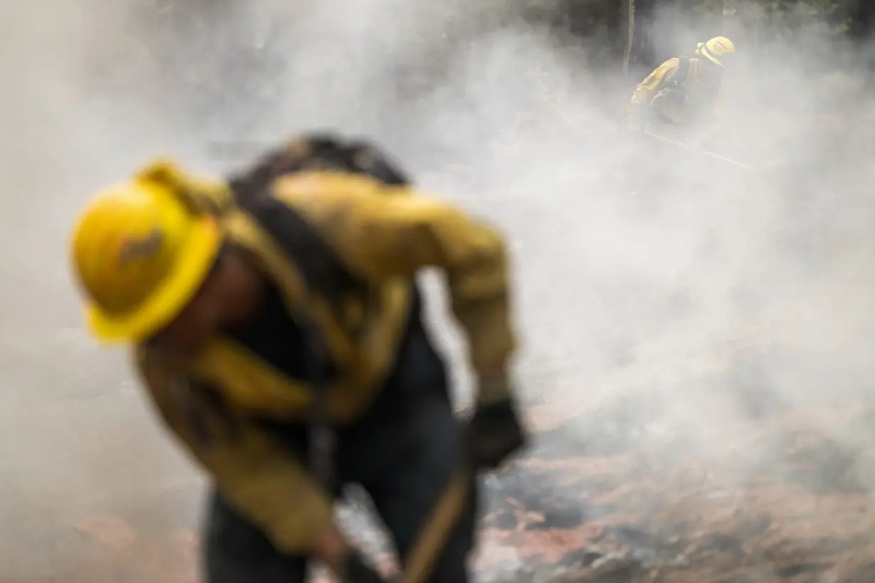 Firefighters helped by cooler weather battle blaze that has scorched area larger than Los Angeles