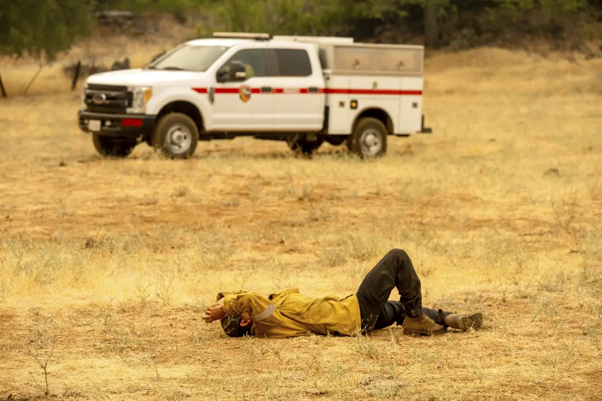 Firefighters helped by cooler weather battle blaze that has scorched area larger than Los Angeles