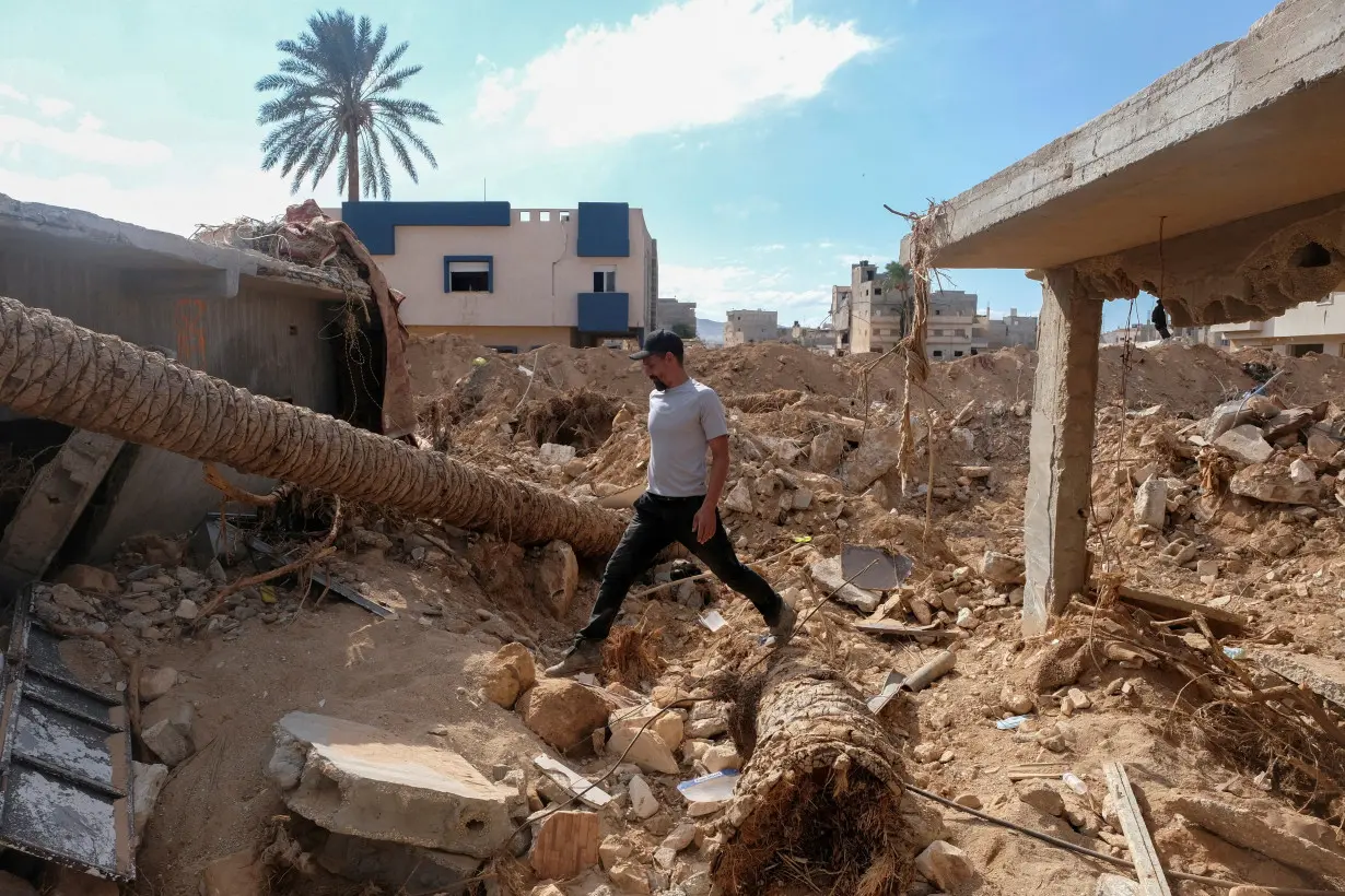 FILE PHOTO: Abdul Salam Ibrahim Al-Qadi, 43 years old, walks on the rubble in front of his house, searching for his missing father and brother after the deadly floods in Derna