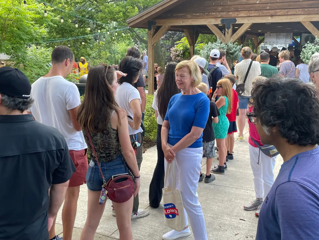 Tammy Baldwin talks with voters at the Port Fish Days festival in Port Washington, Wisconsin, on July 20.