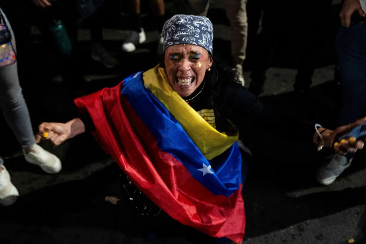 Venezuelan opposition supporters react outside the Venezuelan Embassy, in Mexico City