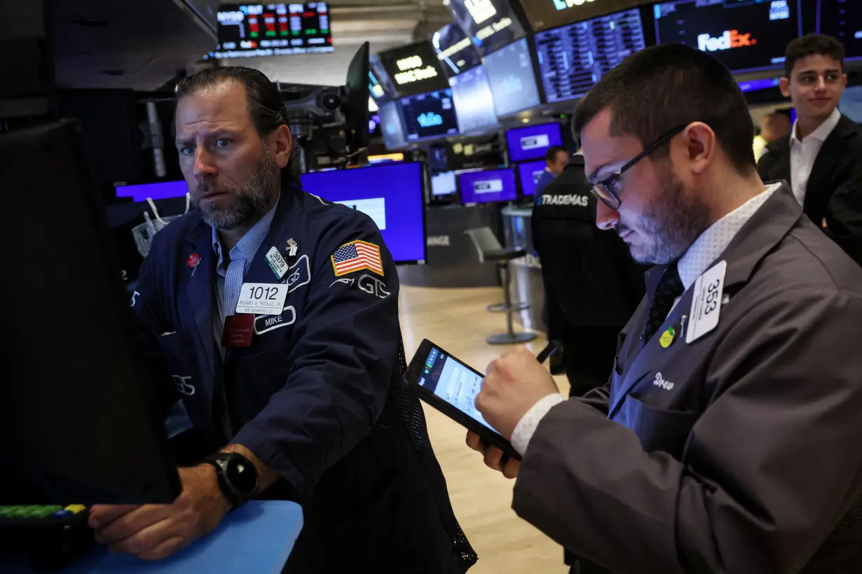 Traders work on the floor of the NYSE in New York