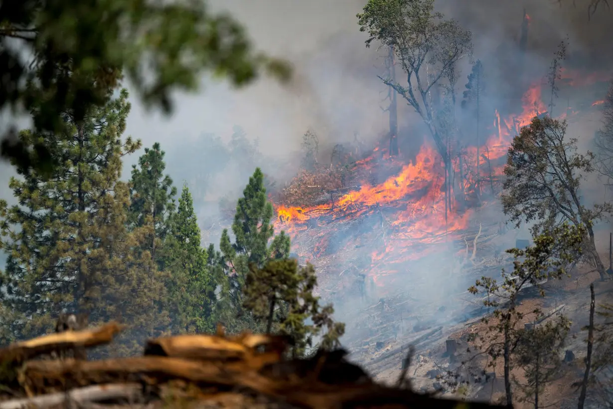 Firefighters cautiously watch the weather as Western wildfires spread