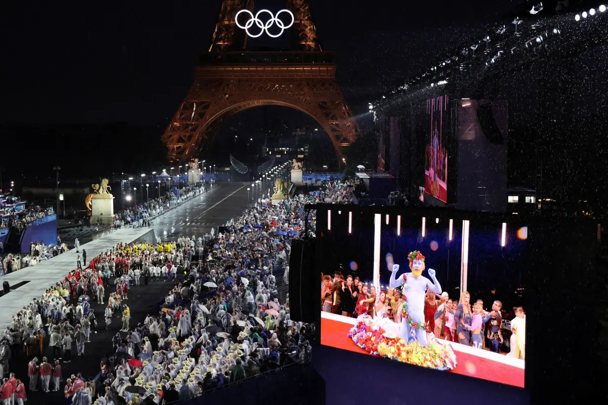 Delegations arrive at the Trocadero in Paris, as spectators watch French singer Philippe Katerine performing on a giant screen during the opening ceremony of the Paris 2024 Olympic Games on July 26.