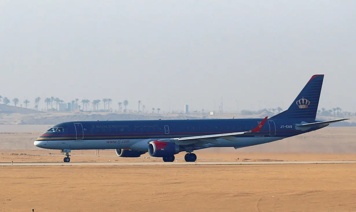 A Royal Jordanian Airlines Embraer ERJ-195AR plane waits to take off on the runway at Cairo Airport