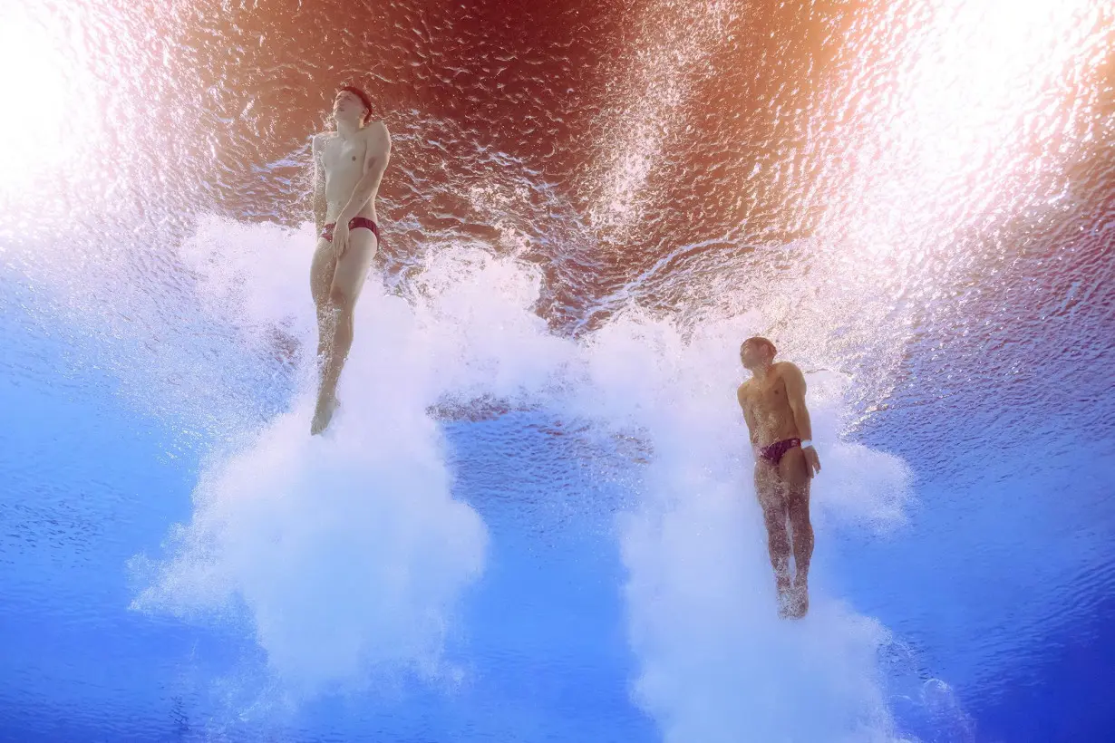 Noah Williams (left) and Tom Daley compete at Paris' Aquatics Center.