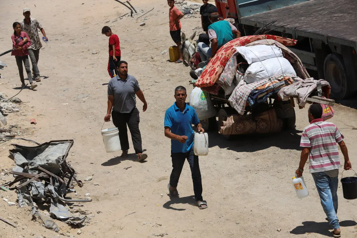 Palestinians gather to collect water amid shortages in Khan Younis in the southern Gaza Strip