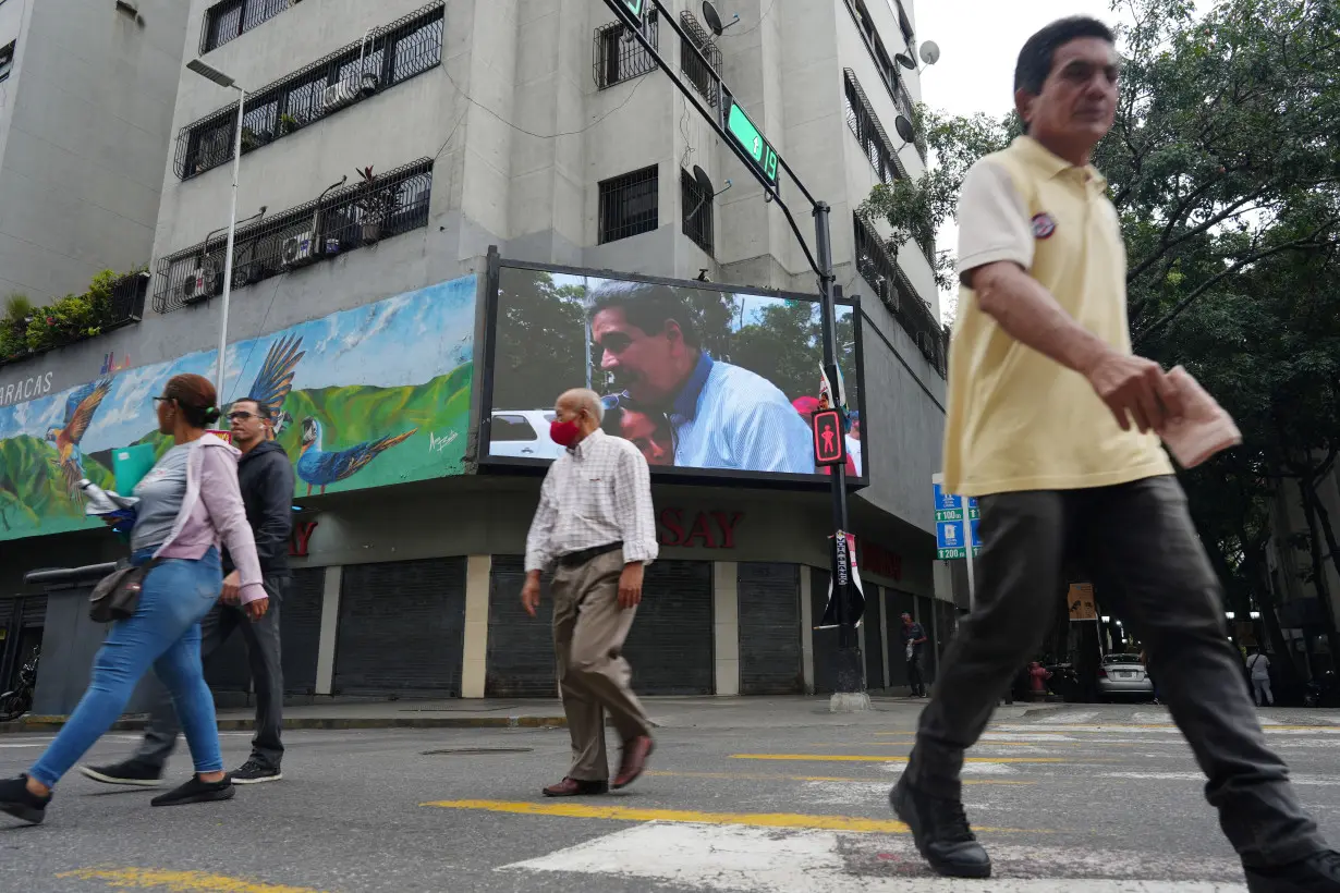 A screen displays an image of President Maduro on the street a day after of Venezuela's presidential election in Caracas