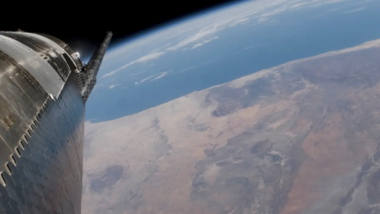 SpaceX Starship passes over the earth during its fourth flight test from the company's Boca Chica launchpad