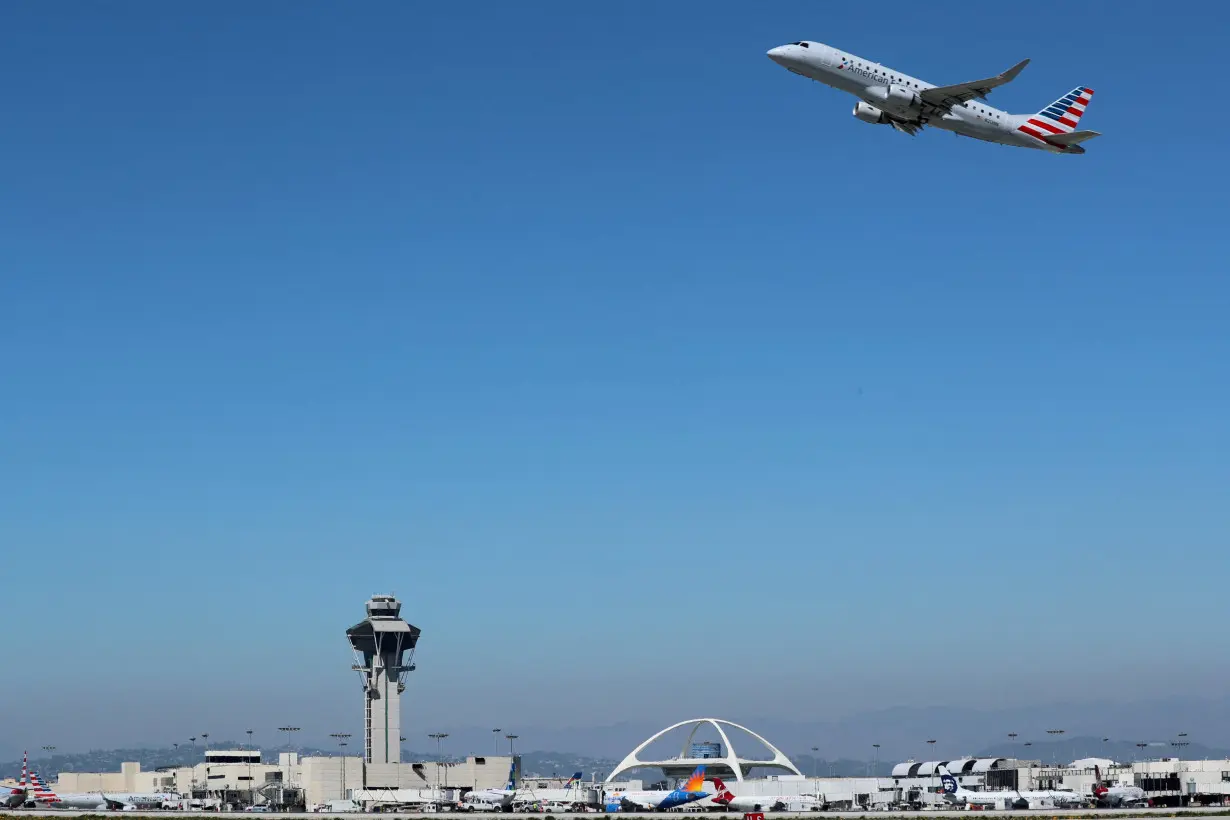 FILE PHOTO: An American Airlines Embraer ERJ-175LR plane takes off from Los Angeles International airport