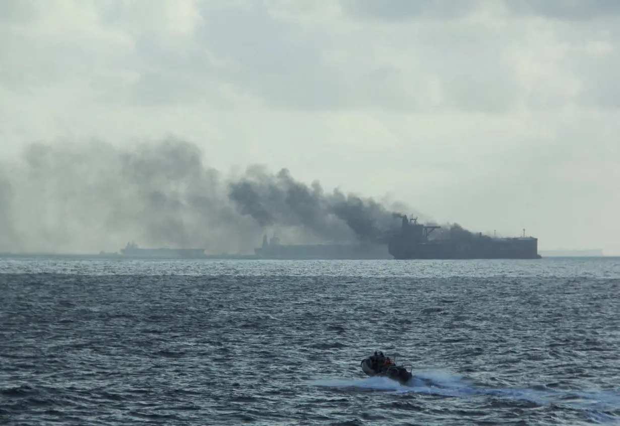 FILE PHOTO: Rescue teams reach oil tankers on fire off the Singaporean island of Pedra Branca