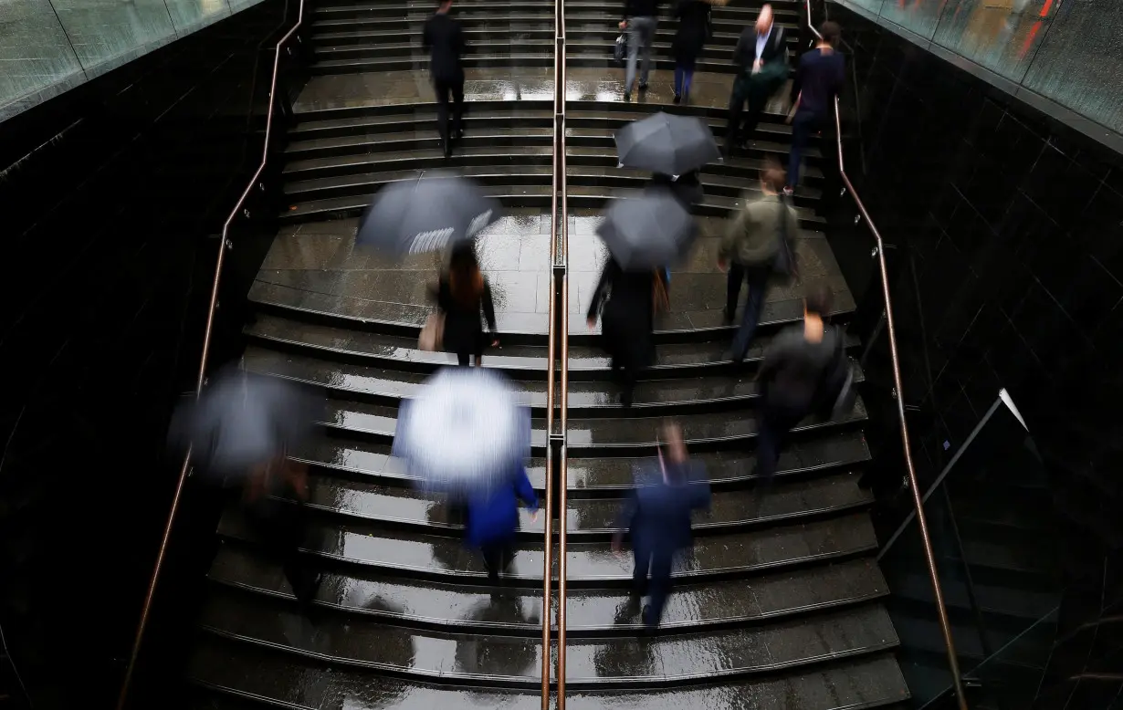 FILE PHOTO: Commuters arrive to the Central Business District at the morning rush hour in Sydney