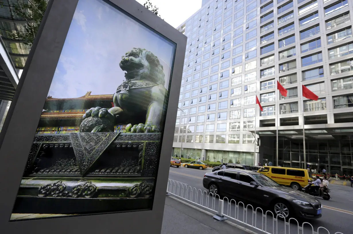 FILE PHOTO: FILE PHOTO: Advertising board showing a Chinese stone lion near an entrance to the headquarters of China Securities Regulatory Commission, in Beijing