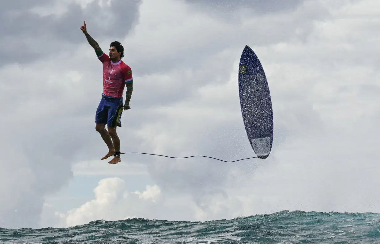 Brazil's Gabriel Medina reacts after his monster 9.90 score in the 5th heat of the men's surfing round 3 on the French Polynesian Island of Tahiti on July 29.